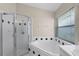 Bathroom with shower, corner tub, and window at 2196 Eh Pounds Dr, Ocoee, FL 34761