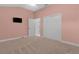 Light pink bedroom with a large closet and door to bathroom at 3113 Sweetgum St, The Villages, FL 32163