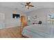 Bedroom with hardwood floors, ceiling fan and a large wooden armoire at 3113 Sweetgum St, The Villages, FL 32163