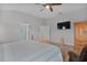 Bright bedroom with a ceiling fan and large TV at 3113 Sweetgum St, The Villages, FL 32163
