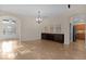 Open dining room with tile floors and a built-in wine rack at 3113 Sweetgum St, The Villages, FL 32163