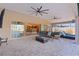 Covered patio with kitchen view and comfortable seating at 3113 Sweetgum St, The Villages, FL 32163