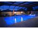 Stunning pool at night with blue lighting, fire features, and seating at 3113 Sweetgum St, The Villages, FL 32163