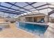 Relaxing pool with covered patio, fire pit, and outdoor seating at 3113 Sweetgum St, The Villages, FL 32163