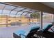 Enclosed pool with water feature and lounge chairs at 3113 Sweetgum St, The Villages, FL 32163