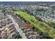 Aerial view of property near golf course, lake, and neighborhood at 3213 Archer Ave, The Villages, FL 32162