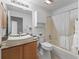 Bathroom features a modern vessel sink, granite countertops, and a tub with a shower at 3213 Archer Ave, The Villages, FL 32162