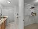 Well-lit bathroom with granite countertop, walk-in shower, and a spacious walk-in closet at 3213 Archer Ave, The Villages, FL 32162