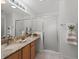 Bright bathroom featuring a granite countertop, vessel sink and glass shower door at 3213 Archer Ave, The Villages, FL 32162