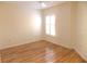 A light and bright empty bedroom with wood floors and a ceiling fan at 3213 Archer Ave, The Villages, FL 32162