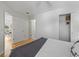 Bedroom featuring wood floors, closet, and ensuite bath at 3213 Archer Ave, The Villages, FL 32162