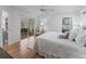 Bright bedroom with hardwood floors, a ceiling fan, and sliding glass doors to a screened lanai at 3213 Archer Ave, The Villages, FL 32162