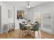Bright dining area with hardwood floors, natural lighting, and a view into the kitchen at 3213 Archer Ave, The Villages, FL 32162