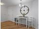 Dining room with hardwood floors, a stylish light fixture, and a wall with a decor clock at 3213 Archer Ave, The Villages, FL 32162