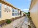 Stylish home exterior featuring a serene walkway with a decorative tree wall hanging at 3213 Archer Ave, The Villages, FL 32162