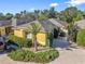 Inviting villa with lush, mature landscaping, a well-manicured lawn, and a private driveway at 3213 Archer Ave, The Villages, FL 32162