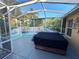 Screened-in porch area features a hot tub with custom waterfall mural at 3213 Archer Ave, The Villages, FL 32162