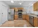 Stainless steel kitchen appliances, granite countertops, and light wood flooring at 3213 Archer Ave, The Villages, FL 32162