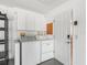 Laundry area with washer, dryer, storage cabinets, and a utility sink at 3213 Archer Ave, The Villages, FL 32162
