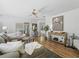 Open living space with hardwood floors, neutral decor, and a view into the bedroom at 3213 Archer Ave, The Villages, FL 32162