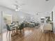 Open-concept living room and dining room with hardwood floors and bright, natural lighting at 3213 Archer Ave, The Villages, FL 32162