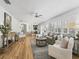 Spacious living room with hardwood floors, comfortable seating, and a seamless flow to the dining area at 3213 Archer Ave, The Villages, FL 32162