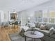Bright living room with hardwood floors, shutters, and view to the dining area and kitchen at 3213 Archer Ave, The Villages, FL 32162