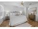 A beautiful main bedroom boasts wood floors, a ceiling fan, and a gorgeous dresser at 3213 Archer Ave, The Villages, FL 32162