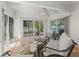 Enclosed patio features terracotta tile, a ceiling fan and access to the pool area at 3213 Archer Ave, The Villages, FL 32162