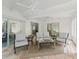 Comfortable covered patio with terracotta flooring and neutral colored outdoor furniture at 3213 Archer Ave, The Villages, FL 32162