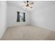 Spacious bedroom with neutral carpeting and ceiling fan at 4287 Fredda Ter, The Villages, FL 32163