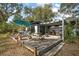 Deck with pergola, umbrella, picnic table, and fire pit at 505 W Catawba St, Fruitland Park, FL 34731