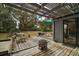 Wooden patio with pergola, seating, fire pit and grill at 505 W Catawba St, Fruitland Park, FL 34731