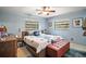Cozy bedroom featuring a ceiling fan, two windows and neutral tones, creating a peaceful retreat at 505 W Catawba St, Fruitland Park, FL 34731
