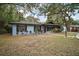 Landscaped front yard with walkway leading to a light blue home at 505 W Catawba St, Fruitland Park, FL 34731