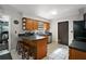 Functional kitchen with breakfast bar, wood cabinets and modern appliances at 505 W Catawba St, Fruitland Park, FL 34731