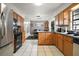 Spacious kitchen has stainless steel appliances, a central island, and open access to the dining area at 505 W Catawba St, Fruitland Park, FL 34731