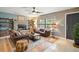 Warm and inviting living room with a stone fireplace and leather furniture at 505 W Catawba St, Fruitland Park, FL 34731
