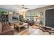 Cozy living room featuring a stone fireplace and leather furniture at 505 W Catawba St, Fruitland Park, FL 34731