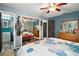 Comfortable bedroom features an en-suite bathroom, closet and bright natural light from the window at 505 W Catawba St, Fruitland Park, FL 34731