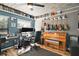 Bright music room with piano, guitars, and workspace at 505 W Catawba St, Fruitland Park, FL 34731