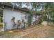 Side view of house with walkway and landscaping at 505 W Catawba St, Fruitland Park, FL 34731