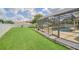 Well-maintained backyard featuring a screened-in pool, spa, and manicured lawn at 6607 Crestmont Glen, Windermere, FL 34786