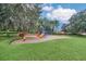 Community playground with colorful play structures and ample green space for outdoor fun at 6607 Crestmont Glen, Windermere, FL 34786