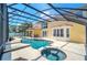 Stunning screened-in pool and spa with ample patio space and beautiful backyard views at 6607 Crestmont Glen, Windermere, FL 34786