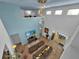 Bright living room featuring soaring ceilings, tile flooring, a modern chandelier and neutral decor at 9249 Ivywood St, Clermont, FL 34711