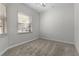 Neutral bedroom with soft carpet, a window, and a ceiling fan at 1018 Green Gate Blvd, Groveland, FL 34736