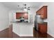 Open-concept kitchen with stainless steel appliances, wood cabinets, and breakfast bar at 1018 Green Gate Blvd, Groveland, FL 34736