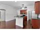 Bright kitchen boasts dark wood cabinetry, granite countertops, and stainless steel appliances at 1018 Green Gate Blvd, Groveland, FL 34736