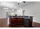 Kitchen features dark wood cabinets, granite counters, and hardwood floors at 1018 Green Gate Blvd, Groveland, FL 34736